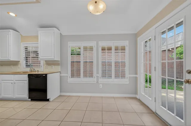 a view of an empty room with a kitchen