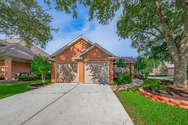 a front view of a house with a yard and potted plants