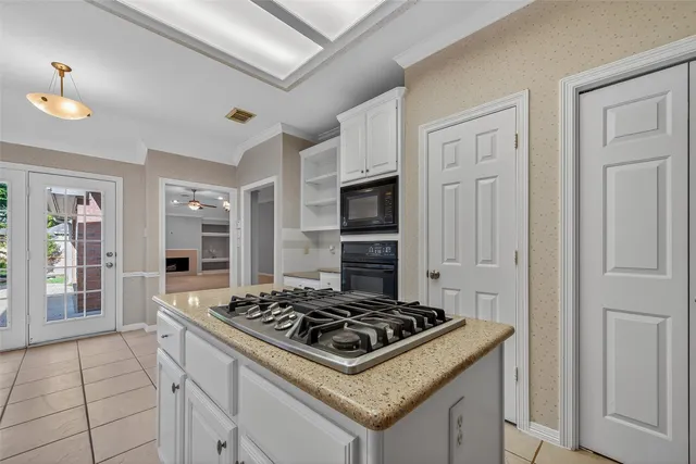a white stove top oven sitting inside of a kitchen