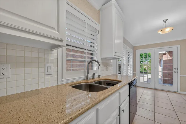 a kitchen with a sink and cabinets