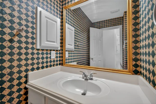 a bathroom with a sink and a mirror