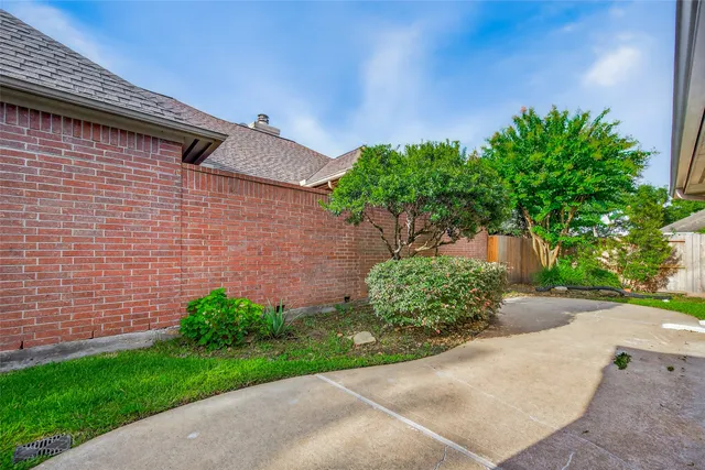 a brick building with a small yard