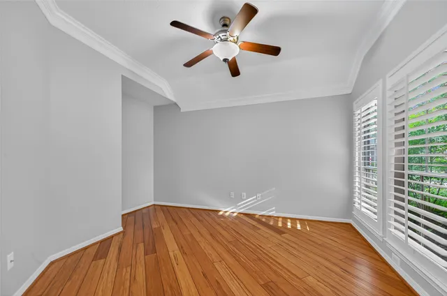 wooden floor in an empty room with a window