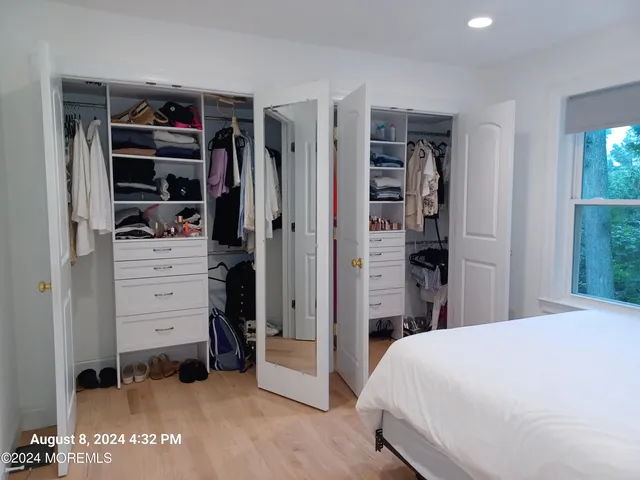 a bedroom with a bed and a walk in closet