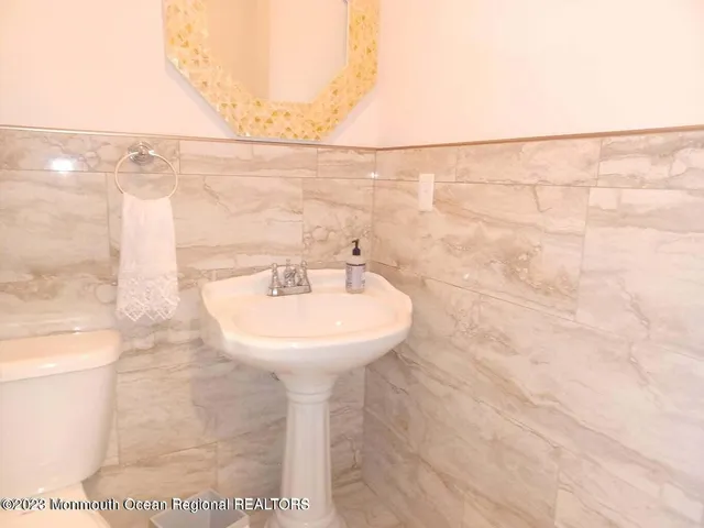 a bathroom with a sink a mirror and shower