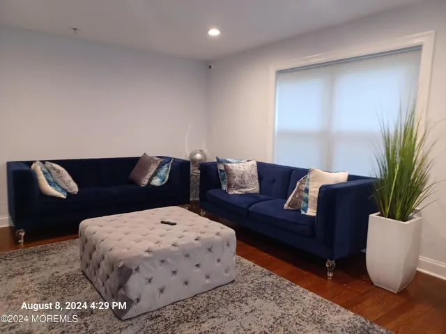 a living room with furniture flowerpot and a window