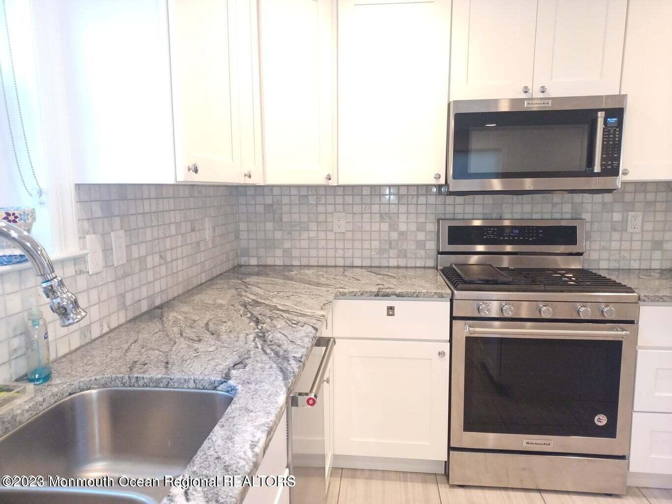 241 Woodcrest Road Oakhurst, NJ 07755 - Photo 5 of 19 a stove top oven sitting inside of a kitchen