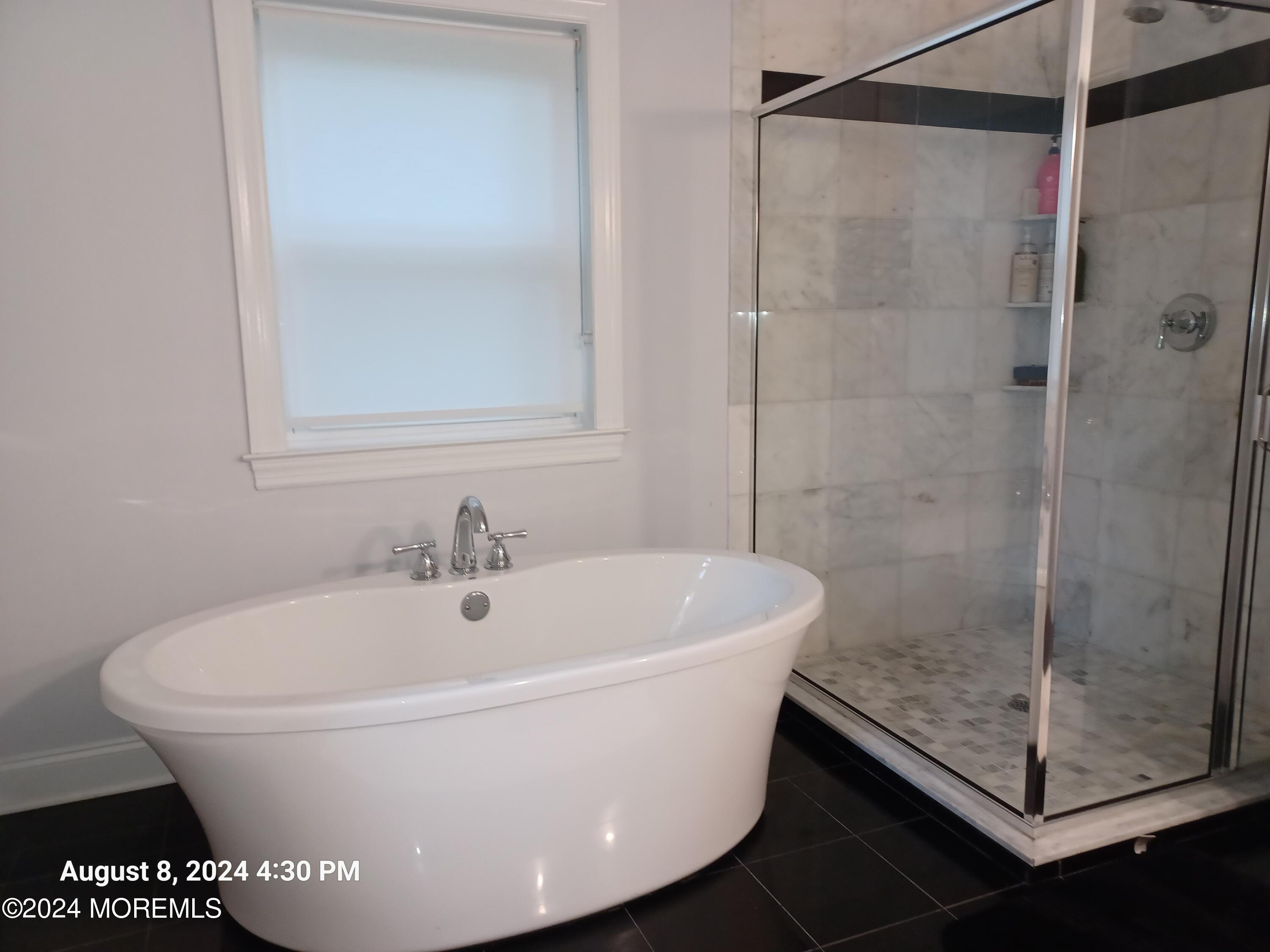 241 Woodcrest Road Oakhurst, NJ 07755 - Photo 8 of 19 a white bath tub sitting next to a shower