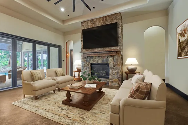 a living room with furniture a flat screen tv and a fireplace