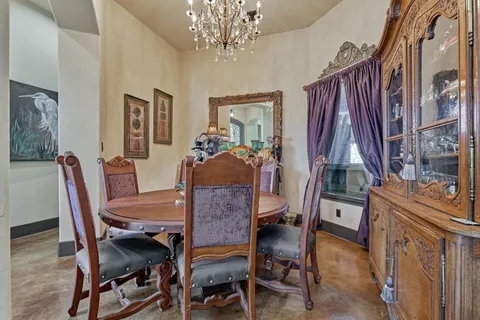 a view of a dining room with furniture and a chandelier