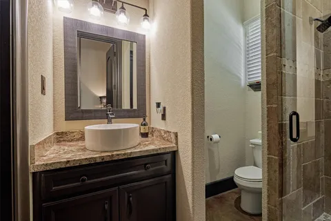 a bedroom with bed and wooden floor