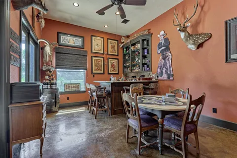 a bathroom with a granite countertop toilet sink and mirror