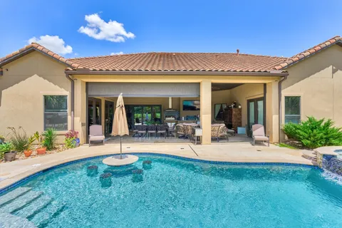 a view of a swimming pool with a patio