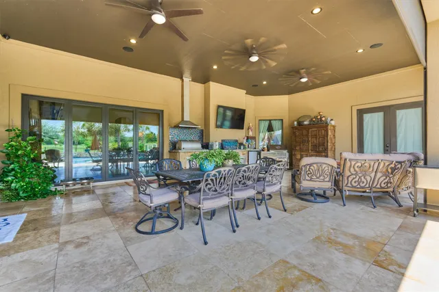 a view of a house with backyard porch and sitting area