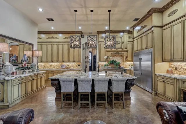 a kitchen with lots of counter space and stainless steel appliances