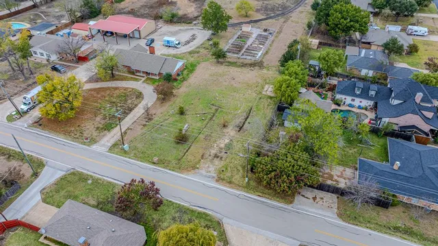 an aerial view of a residential houses with outdoor space
