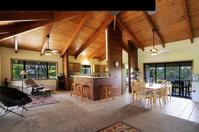 141 West Kuiaha Road Haiku, HI 96708 - Photo 1 of 15 a living room with furniture a fireplace and large windows