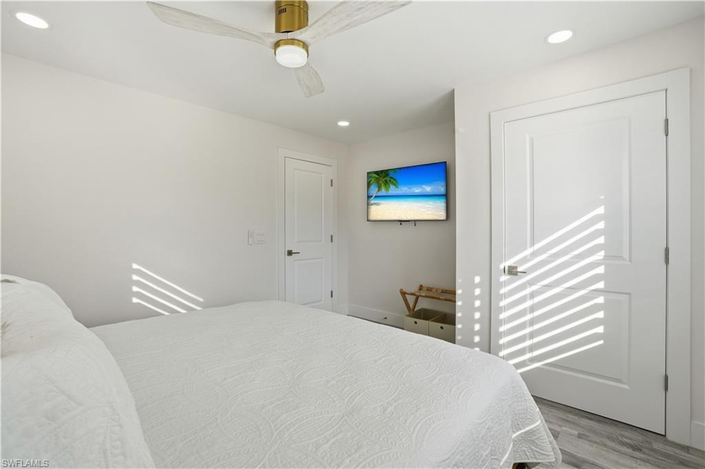 270 Dundee Road Fort Myers Beach, FL 33931 - Photo 29 of 48 Bedroom featuring recessed lighting, wood finished floors, and ceiling fan - Virtually Edited Image