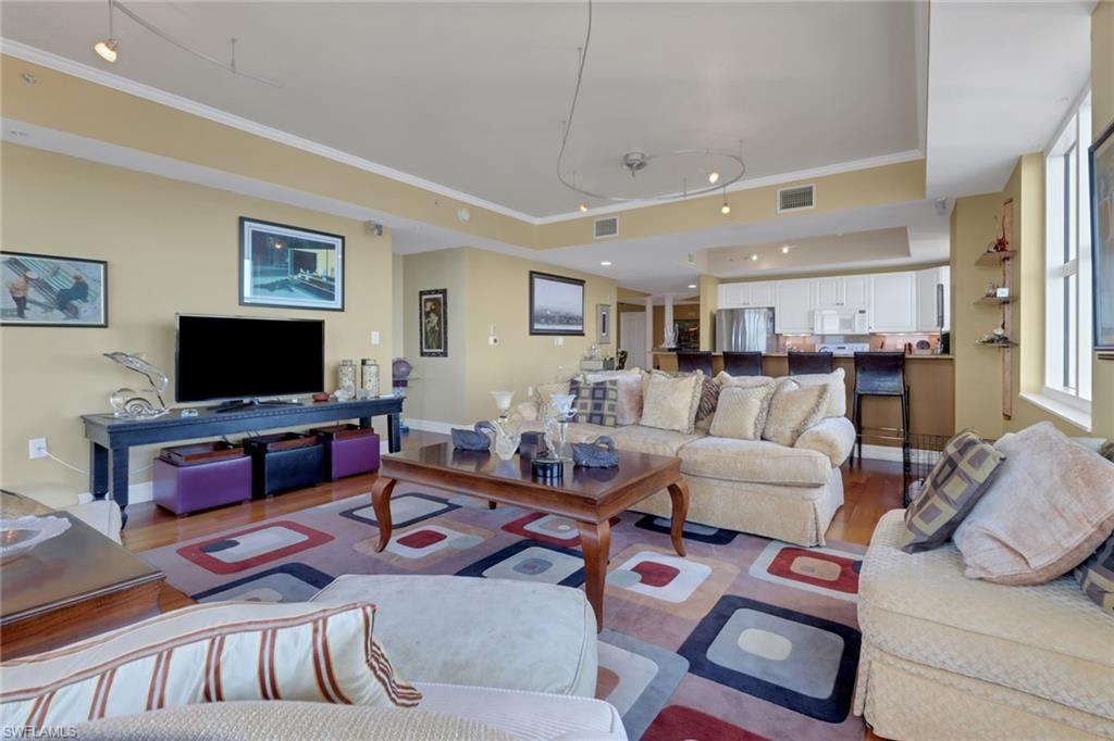 2797 First Street, Unit 1001 Fort Myers, FL 33916 - Photo 12 of 41 a living room with furniture a flat screen tv and a table