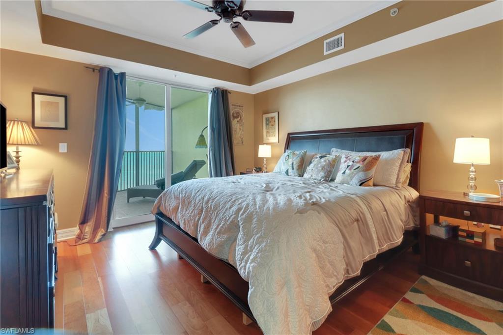 2797 First Street, Unit 1001 Fort Myers, FL 33916 - Photo 16 of 41 a bedroom with a bed and a chandelier