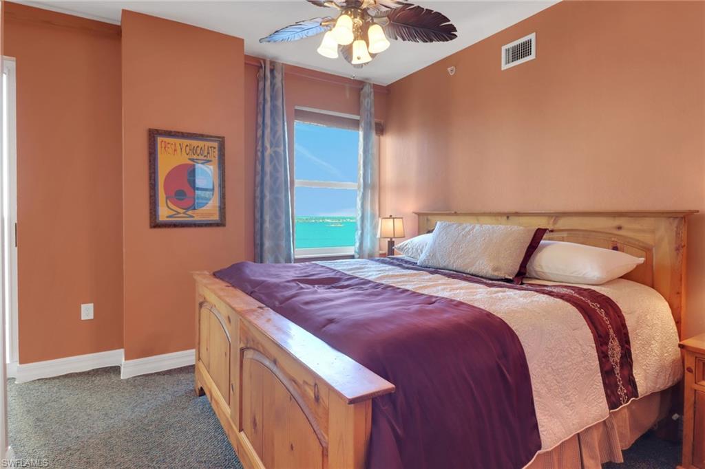 2797 First Street, Unit 1001 Fort Myers, FL 33916 - Photo 20 of 41 a bedroom with a bed and a chandelier