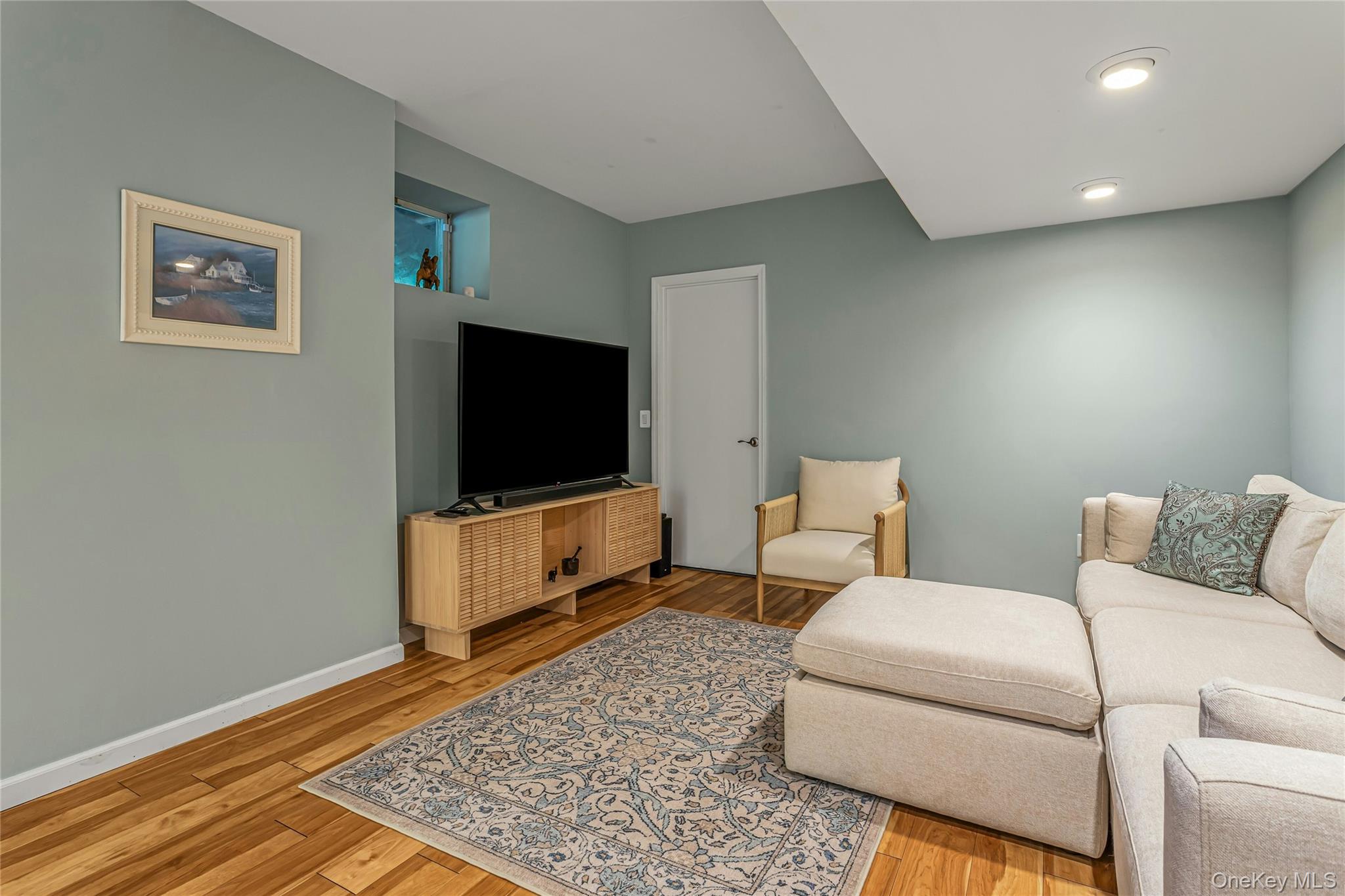 340 Osceola Road Jefferson Valley, NY 10535 - Photo 28 of 48 a living room with furniture and a flat screen tv