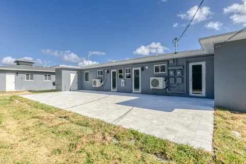 a view of a house with backyard porch and sitting area