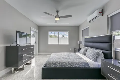 a bedroom with a bed and a flat screen tv
