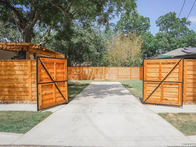 a view of backyard with a small deck and a garden
