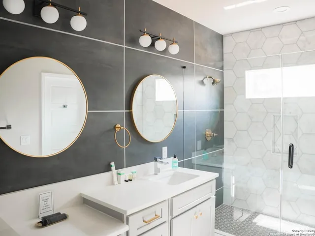 a bathroom with a sink mirror and vanity
