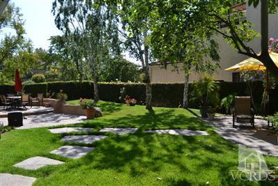 11653 Chestnut Ridge Street Moorpark, CA 93021 - Photo 5 of 17 a backyard of a house with table and chairs floor to ceiling window and wooden fence