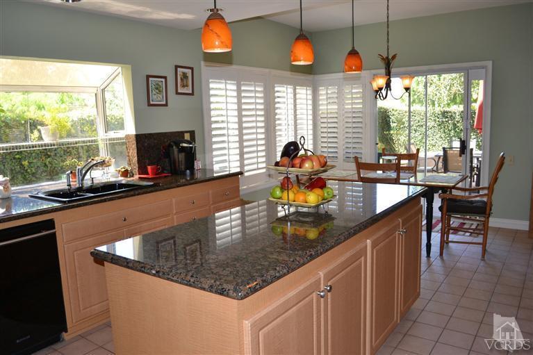 11653 Chestnut Ridge Street Moorpark, CA 93021 - Photo 6 of 17 a kitchen with stainless steel appliances granite countertop a sink a stove and a wooden cabinets