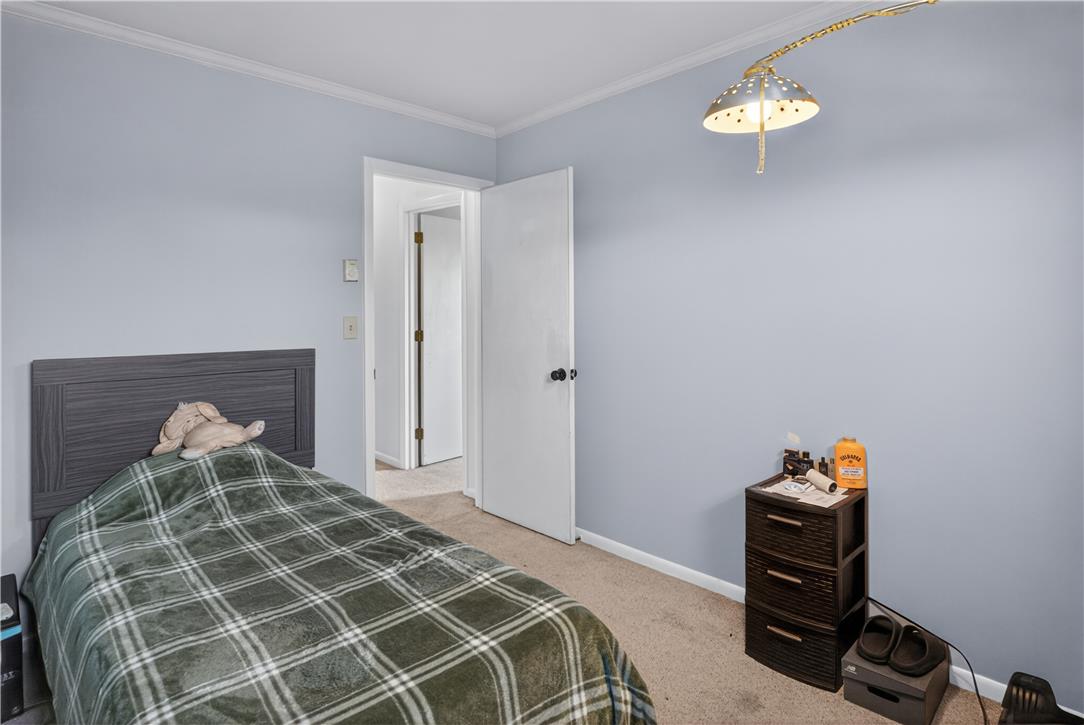 479 South 9th Street Akron, PA 17501 - Photo 21 of 33 A restful bedroom offers a cozy sleeping area, featuring carpet flooring and ample natural light.