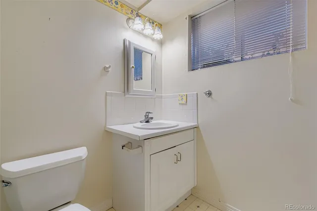 a bathroom with a sink a toilet and mirror