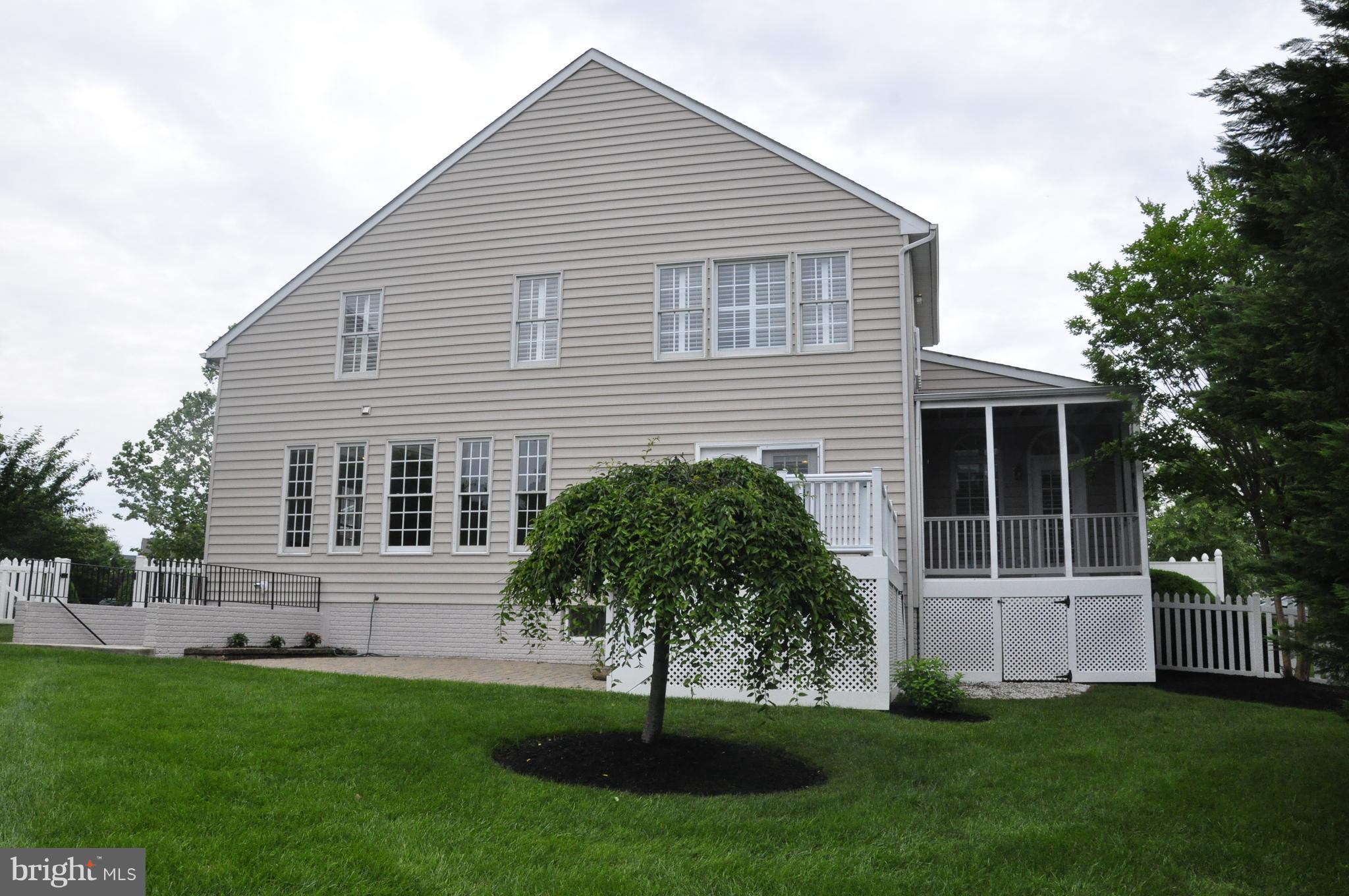 18308 Crestmount Road Boyds, MD 20841 - Photo 3 of 24 a front view of a house with a garden and plants