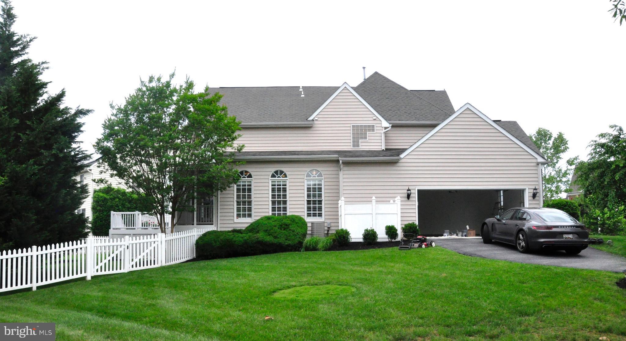 18308 Crestmount Road Boyds, MD 20841 - Photo 4 of 24 a front view of a house with a garden and trees