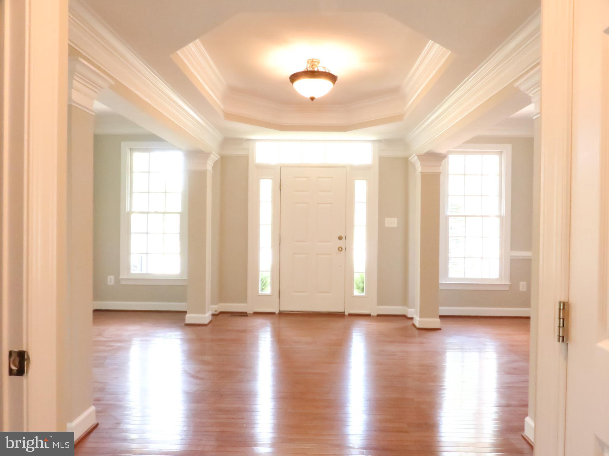 18308 Crestmount Road Boyds, MD 20841 - Photo 7 of 24 a view of empty room with wooden floor and fan