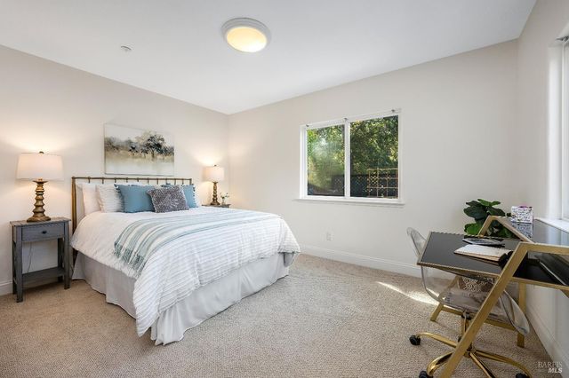 a bed room with a bed and a chair