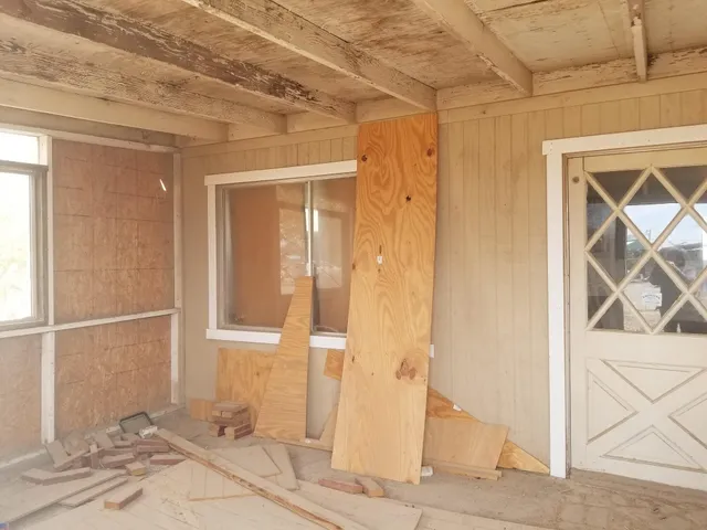 a view of a hallway with a mirror and a window