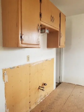 a room with wooden floor and furniture