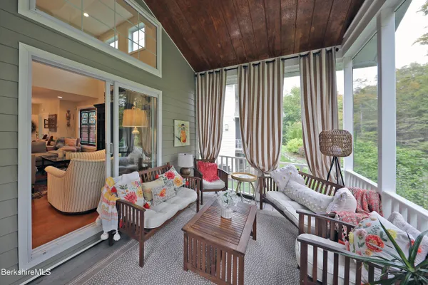 a living room filled with furniture and a large window