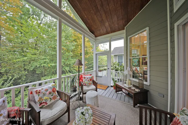 a living room with large windows and furniture