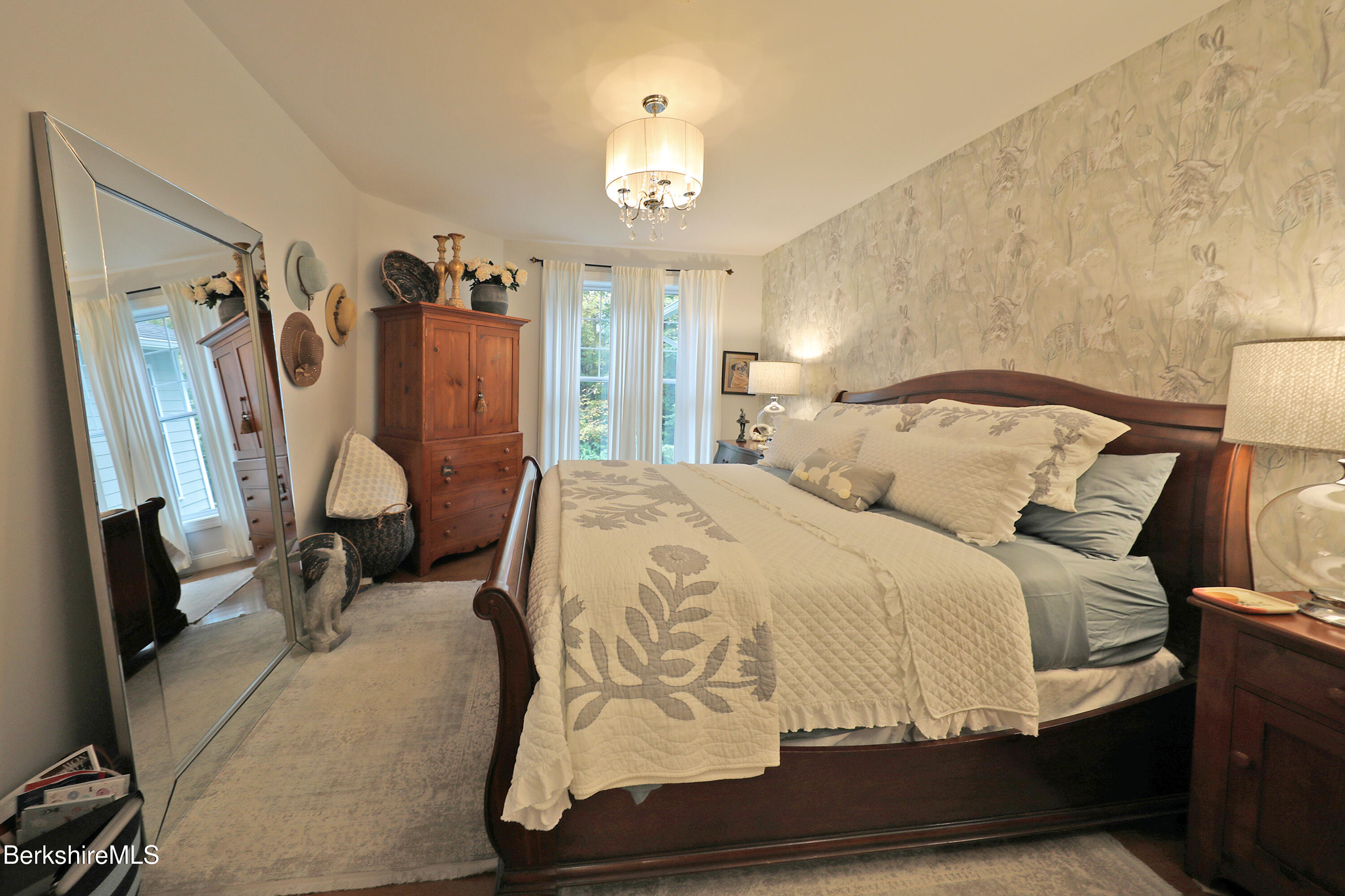 103 Alpine Trail Pittsfield, MA 01201 - Photo 19 of 39 a bedroom with a bed and a chandelier