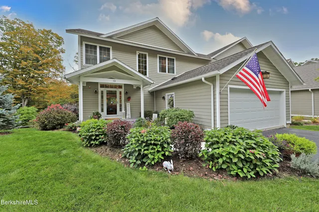 a front view of a house with a garden
