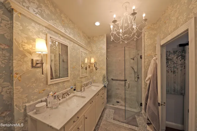 a spacious bathroom with a shower sink and mirror