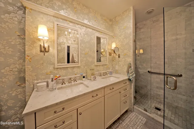 a spacious bathroom with a shower sink and mirror