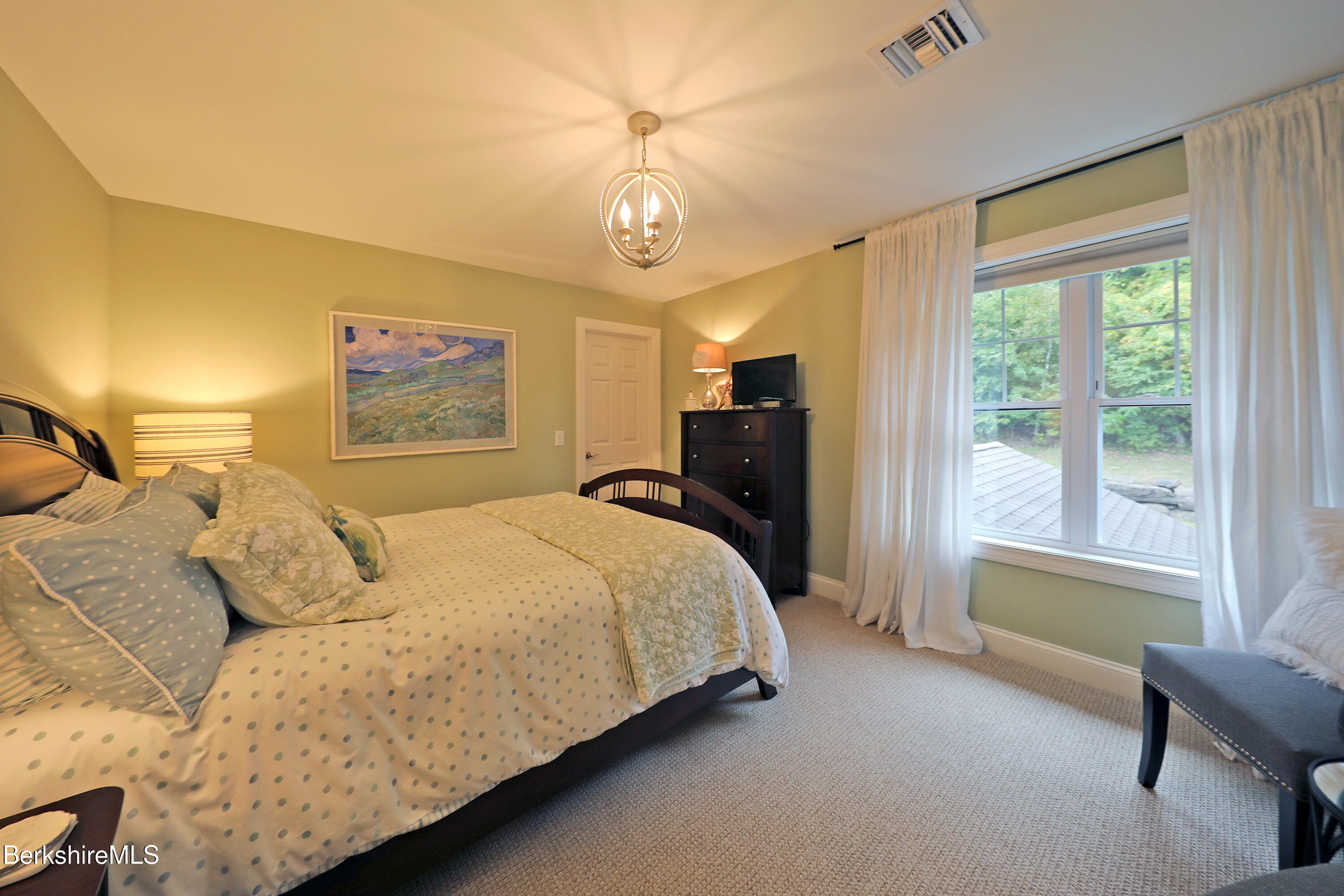 103 Alpine Trail Pittsfield, MA 01201 - Photo 33 of 39 a spacious bedroom with a bed and a chandelier