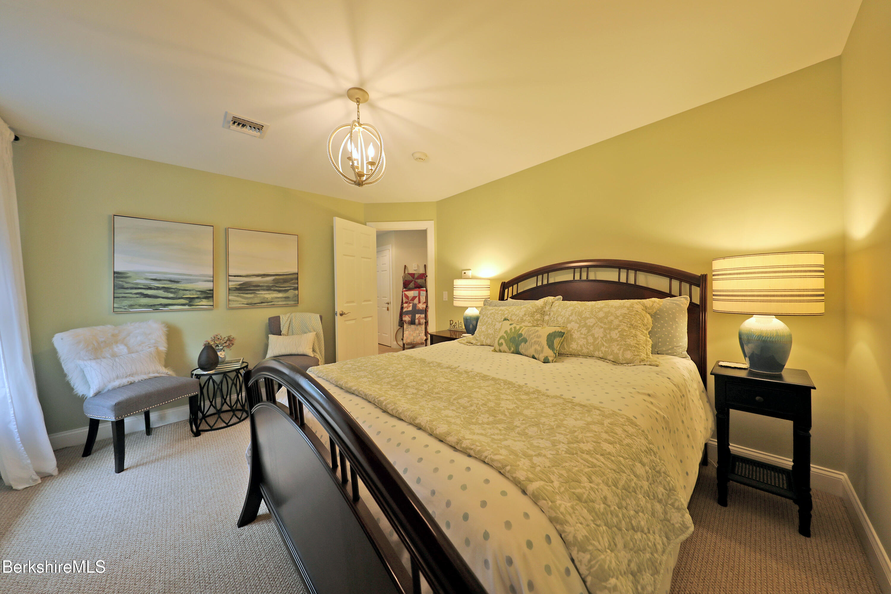 103 Alpine Trail Pittsfield, MA 01201 - Photo 34 of 39 a bedroom with a bed and a chandelier