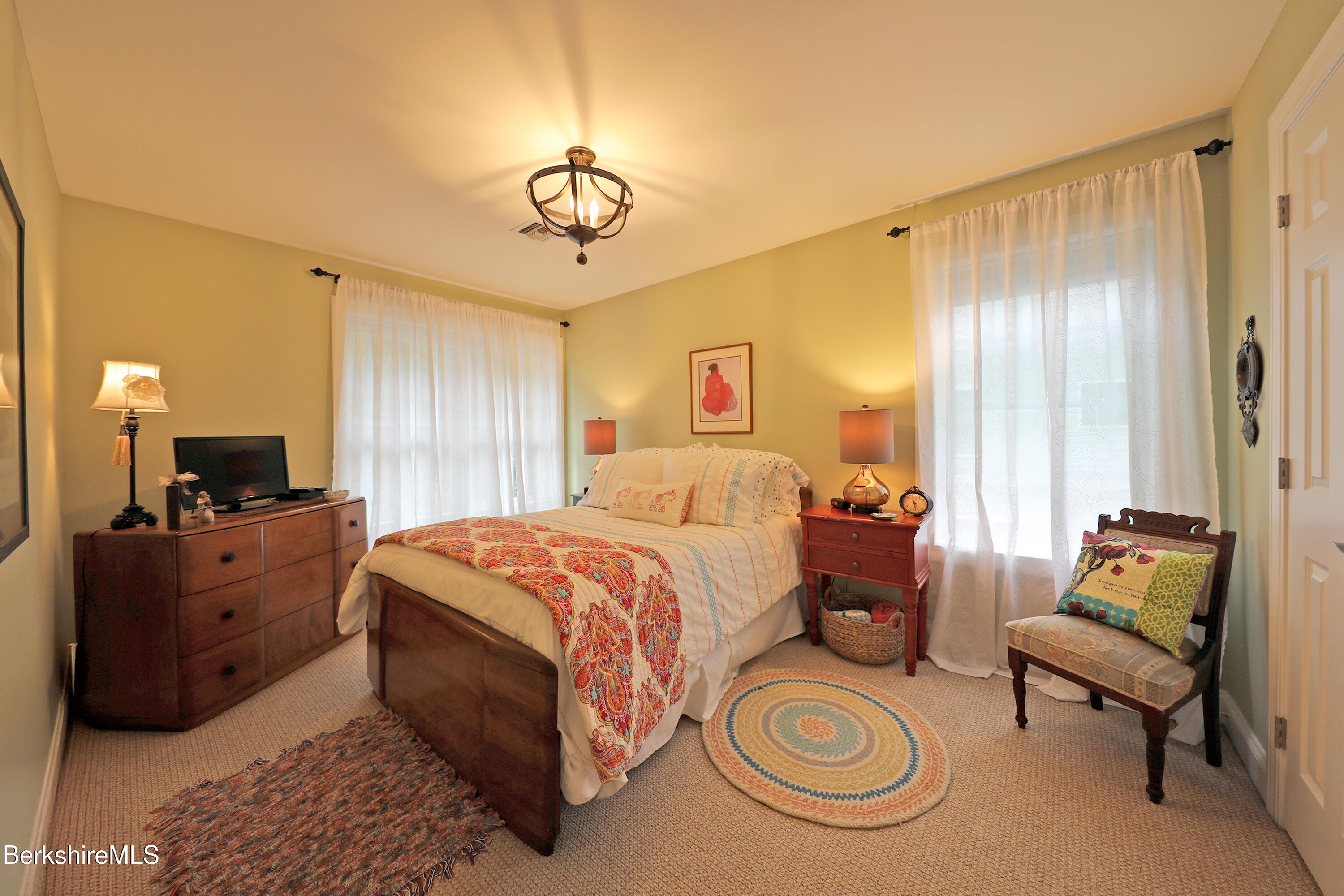 103 Alpine Trail Pittsfield, MA 01201 - Photo 36 of 39 a spacious bedroom with a bed and a chandelier