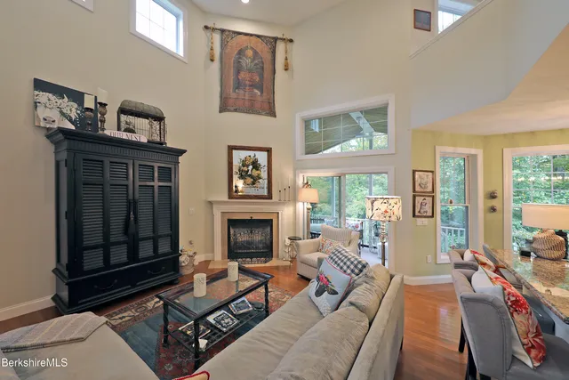 a living room with furniture a flat screen tv and a fireplace